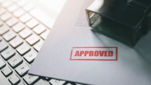 210302135256 underscored red approval stamp on documents